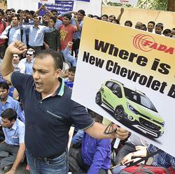 Federation of Automobiles dealers Associations (FADA) and Chevrolet India dealers protest along with their employees at Jantar Mantar in New Delhi on Tuesday against General Motors after the American automaker abruptly decided to stop the sales of their Chevrolet branded car in the Indian market.