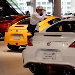 A man walks in the Nissan showroom at the carmaker's headquarters in Yokohama. A man walks in the Nissan showroom at the carmaker's headquarters in Yokohama.