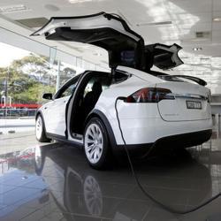 A Tesla wall connector demonstrates the charging at home of a Model X vehicle at a Tesla electric car dealership in Sydney, Australia. A Tesla wall connector demonstrates the charging at home of a Model X vehicle at a Tesla electric car dealership in Sydney, Australia.