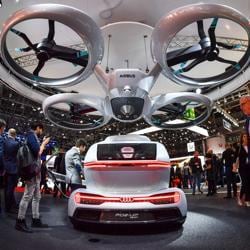 The "Pop.up next" concept flying car, a hybrid vehicle that blends a self-driving car and passenger drone by Audi, italdesign and Airbus is seen during the first press day of the Geneva International Motor Show on March 6, 2018 in Geneva. The "Pop.up next" concept flying car, a hybrid vehicle that blends a self-driving car and passenger drone by Audi, italdesign and Airbus is seen during the first press day of the Geneva International Motor Show on March 6, 2018 in Geneva.