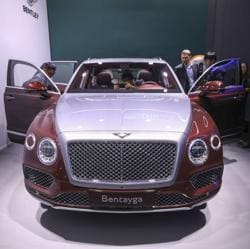 Attendees look at a Bentley Motors Ltd. Bentayga luxury vehicle ahead of the 88th Geneva International Motor Show in Geneva, Switzerland, on Monday, March 5, 2018. Photographer: Chris Ratcliffe/Bloomberg