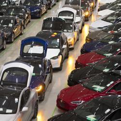 A line of new Tesla Model X sports utility vehicles (SUV), centre, sit with Tesla Model S automobiles following assembly for the European market at the Tesla Motors Inc. factory in Tilburg, Netherlands. A line of new Tesla Model X sports utility vehicles (SUV), centre, sit with Tesla Model S automobiles following assembly for the European market at the Tesla Motors Inc. factory in Tilburg, Netherlands.
