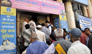 Senior citizens wait outside an SBI branch to open to withdraw pension in Indore on Thursday.(Arun Mondhe / HT photo)