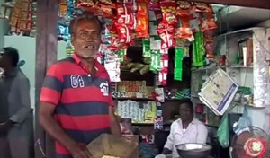 Labourer Motiram exchanges food grains for other essentials at a grocery store in Kanariya, Khargone district on Thursday.(HT photo)