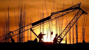 Construction workers work at a site as the sun sets in Chandigarh December 16, 2006. REUTERS/Ajay Verma/Files(REUTERS)