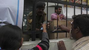 A woman enters her pin number after swiping her debit card to withdraw cash outside a State Bank of India branch in Hyderabad.(AP) A woman enters her pin number after swiping her debit card to withdraw cash outside a State Bank of India branch in Hyderabad.(AP)