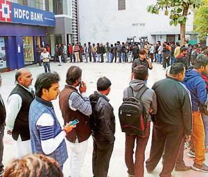 People stand in a long queue to withdraw currency notes at ATM. Most ATMs have been dispensing only 2,000 rupee notes.(PTI) People stand in a long queue to withdraw currency notes at ATM. Most ATMs have been dispensing only 2,000 rupee notes.(PTI)