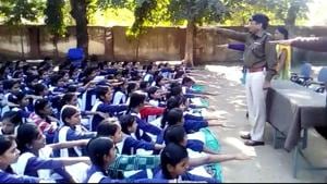 Girls students being administered oath that they would study till 18 years,under an initiative taken by Jhabua police.(HT photo)