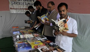 Students go through books at a stall at the ABVP national conference at GACC in Indore on Tuesday.(Arun Mondhe/HT photo)