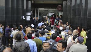 People wait outside a bank to withdraw money in New Delhi.(AP File Photo) People wait outside a bank to withdraw money in New Delhi.(AP File Photo)
