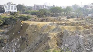 A seasonal water body in DLF phase 3 was continuously filled with construction waste last year. Similar incidents were reported from different parts of the city and the first construction and demolition waste plant to be set up by the MCG is aimed at mitigating the issue.(HT File) A seasonal water body in DLF phase 3 was continuously filled with construction waste last year. Similar incidents were reported from different parts of the city and the first construction and demolition waste plant to be set up by the MCG is aimed at mitigating the issue.(HT File)
