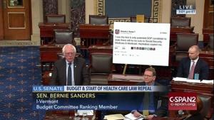 TV screengrab of Bernie Sanders speaking at the US Senate. Behind him a printout of tweet by Donald Trump(Photo: Gizmodo) TV screengrab of Bernie Sanders speaking at the US Senate. Behind him a printout of tweet by Donald Trump(Photo: Gizmodo)