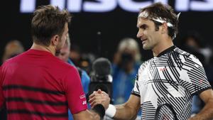 Roger Federer, right, is congratulated by Swiss compatriot Stan Wawrinka, after winning their semifinal at the Australian Open tennis championships in Melbourne on Thursday.(AP) Roger Federer, right, is congratulated by Swiss compatriot Stan Wawrinka, after winning their semifinal at the Australian Open tennis championships in Melbourne on Thursday.(AP)