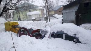 A Kashmiri man checks his vehicle stuck in snow in Tangmarg, about 41 kms northwest of Srinagar on Friday.(AP Photo) A Kashmiri man checks his vehicle stuck in snow in Tangmarg, about 41 kms northwest of Srinagar on Friday.(AP Photo)