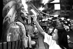 On 1st January, 2000, a bar girl lights some incense to bring good luck and fortune to the go-go bar where she works.(LightRocket via Getty Images) On 1st January, 2000, a bar girl lights some incense to bring good luck and fortune to the go-go bar where she works.(LightRocket via Getty Images)
