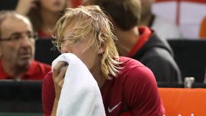 Denis Shapovalov reacts after accidentally hitting chair umpire Arnaud Gabas during a Davis Cup match between Canada and Great Britain.(AFP) Denis Shapovalov reacts after accidentally hitting chair umpire Arnaud Gabas during a Davis Cup match between Canada and Great Britain.(AFP)