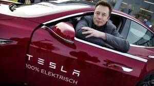 Elon Musk, co-founder and CEO of Tesla, poses with a model of the brand during a visit to Amsterdam, The Netherlands, January 31(EPA)