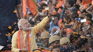 Prime Minister Narendra Modi waves to people during his roadshow in Varanasi on Sunday.(PTI Photo) Prime Minister Narendra Modi waves to people during his roadshow in Varanasi on Sunday.(PTI Photo)