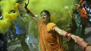 A supporter of BJP celebrates outside the party headquarters in New Delhi after the elections results were announced.(AFP) A supporter of BJP celebrates outside the party headquarters in New Delhi after the elections results were announced.(AFP)