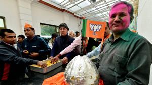 A BJP worker holds a huge laddu during celebrations after the party’s victory in UP and Uttarakhand assembly elections, at the party headquarters in New Delhi on Saturday.(PTI) A BJP worker holds a huge laddu during celebrations after the party’s victory in UP and Uttarakhand assembly elections, at the party headquarters in New Delhi on Saturday.(PTI)