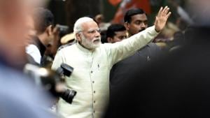 Prime Minister Narendra Modi waves to his supporters as he heads towards the BJP headquarters after victories in Uttar Pradesh and Uttarakhand elections, in New Delhi on Sunday.(Raj K Raj/HT PHOTO)