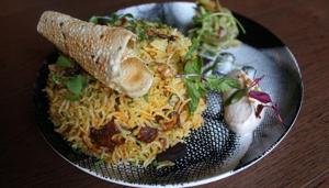 Although there’s barely any vodka in Tamasha’s vodka chicken biryani, the dish is creatively presented, with the masala sandwiched between two bun-shaped layers of rice.(Satyabrata Tripathy/HT Photo)