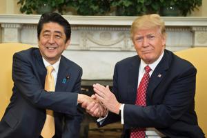 Japan's Prime Minister Shinzo Abe and US President Donald Trump shake hands before a meeting in the Oval Office of the White House on February 10.(AFP)