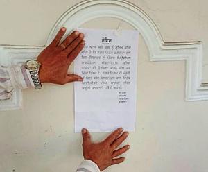 MC officials pasting notice after locking a property.(HT Photo) MC officials pasting notice after locking a property.(HT Photo)