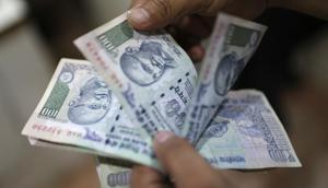 An man counts money inside a private money exchange office in New Delhi.(REUTERS File) An man counts money inside a private money exchange office in New Delhi.(REUTERS File)