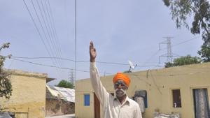 The passing of low-hanging high-tension wires just inches above the roofs of house is grave ganger that affects the lives of residents in the area.(Sant Arora/HT Photo) The passing of low-hanging high-tension wires just inches above the roofs of house is grave ganger that affects the lives of residents in the area.(Sant Arora/HT Photo)