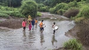 Members of a local adivasi clan cross Dahisar River with an idol of goddess Durga(Courtesy: Aslam Saiyad) Members of a local adivasi clan cross Dahisar River with an idol of goddess Durga(Courtesy: Aslam Saiyad)
