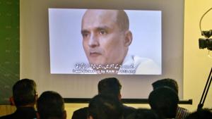 In this file photo, journalists look at an image of former Indian naval officer Kulbhushan Jadhav, who was arrested in March 2016.(AP File Photo) In this file photo, journalists look at an image of former Indian naval officer Kulbhushan Jadhav, who was arrested in March 2016.(AP File Photo)