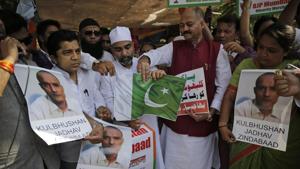 Members of Bharatiya Janata Party Minority Morcha burn a Pakistani flag during a protest against the conviction of a retired Indian naval officer Kulbhushan Jadhav, in Mumbai on Wednesday.(AP) Members of Bharatiya Janata Party Minority Morcha burn a Pakistani flag during a protest against the conviction of a retired Indian naval officer Kulbhushan Jadhav, in Mumbai on Wednesday.(AP)