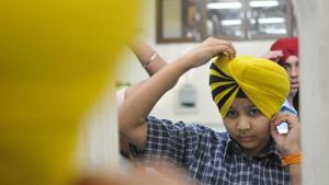 A boy participates in a turban-tying competition held at the Sarabha Nagar gurdwara on the occasion of Baisakhi in Ludhiana on Thursday, April 13.(Gurminder Singh/HT) A boy participates in a turban-tying competition held at the Sarabha Nagar gurdwara on the occasion of Baisakhi in Ludhiana on Thursday, April 13.(Gurminder Singh/HT)