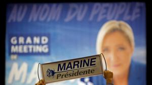 A supporter holds a poster to support Marine Le Pen, French National Front leader and candidate for French presidential election, during a political rally in Perpignan(Reuters) A supporter holds a poster to support Marine Le Pen, French National Front leader and candidate for French presidential election, during a political rally in Perpignan(Reuters)