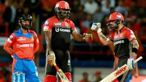 Royal Challengers Bangalore captain Virat Kohli with teammate Chris Gayle during the IPL 2017 T20 match against Gujarat Lions in Rajkot on Tuesday.(PTI) Royal Challengers Bangalore captain Virat Kohli with teammate Chris Gayle during the IPL 2017 T20 match against Gujarat Lions in Rajkot on Tuesday.(PTI)