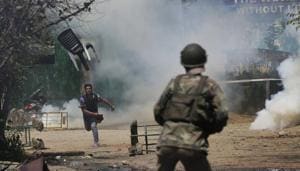 A Kashmiri student throws a chair on policemen in Srinagar, April 17. Kashmir was plunged into turmoil following the killing of the Hizbul leader Burhan Wani. Wani died in July 2016; for weeks afterwards, protesters and police battled it out across the Valley.(AP) A Kashmiri student throws a chair on policemen in Srinagar, April 17. Kashmir was plunged into turmoil following the killing of the Hizbul leader Burhan Wani. Wani died in July 2016; for weeks afterwards, protesters and police battled it out across the Valley.(AP)