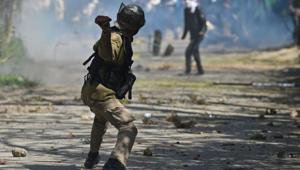 A security personnel throws a stone towards protesters during clashes near a college in central Srinagar's Lal Chowk.(AFP File Photo) A security personnel throws a stone towards protesters during clashes near a college in central Srinagar's Lal Chowk.(AFP File Photo)