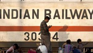 A train engine moves past waiting travellers at a railway station in New Delhi. (AFP Photo) A train engine moves past waiting travellers at a railway station in New Delhi. (AFP Photo)
