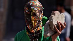 A masked protester holds stones during a protest in Srinagar.(REUTERS) A masked protester holds stones during a protest in Srinagar.(REUTERS)
