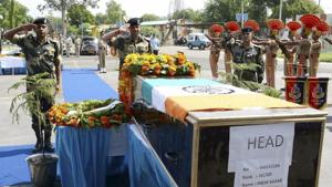 Assistant director general of Border Security Force's Western Command Kamal Nayan Choubey (C) pays his respects to head constable Prem Sagar during a wreath laying ceremony in Jammu on Tuesday.(PTI Photo) Assistant director general of Border Security Force's Western Command Kamal Nayan Choubey (C) pays his respects to head constable Prem Sagar during a wreath laying ceremony in Jammu on Tuesday.(PTI Photo)
