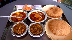 <p>Why the streets of Old Delhi are a food lover's paradise is no secret. Here, every hole-in-the-wall is filled with aromatic, mouth watering and inexpensive food. We once again hunted Chawri Bazaar, this time in search of Bedmi Aloo, a breakfast fare that's both tasty and light on the stomach. The shop that sells this is the hundred-year-old Shyam Sweets, which used to be one of the landmarks of Delhi at some point. Bedmi is stuffed poori layered with a paste of Urad Dal. It is served with a mildly spiced potato curry, lightly cooked chholey and a dollop of some tart fenugreek (methi) chutney. </p>
