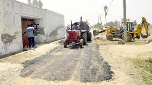 Repairs underway on a road in Vein Poin village in Tarn Taran district on Saturday, May 6.(Sameer Sehagl/HT)