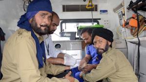 Medics administering first aid to firefighters with minor injuries which they sustained while trying to control a blaze at a textile factory near Cheema Chowk on Thursday.(Gurminder Singh/HT Photo) Medics administering first aid to firefighters with minor injuries which they sustained while trying to control a blaze at a textile factory near Cheema Chowk on Thursday.(Gurminder Singh/HT Photo)
