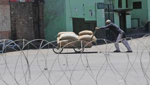 A Kashmiri man pushes his handcart near a barbed wire set up during curfew in downtown area of Srinagar. The government imposed strict curfew in parts of Srinagar on second consecutive day while the unified separatist leadership called for two-day shutdown across Kashmir.(Waseem Andrabi / Hindustan Times) A Kashmiri man pushes his handcart near a barbed wire set up during curfew in downtown area of Srinagar. The government imposed strict curfew in parts of Srinagar on second consecutive day while the unified separatist leadership called for two-day shutdown across Kashmir.(Waseem Andrabi / Hindustan Times)