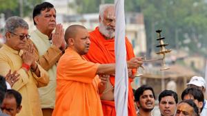 Uttar Pradesh chief minister Yogi Adityanath holds a traditional lamp as he performs prayers on the banks of river Sarayu in Ayodhya on Wednesday.(REUTERS) Uttar Pradesh chief minister Yogi Adityanath holds a traditional lamp as he performs prayers on the banks of river Sarayu in Ayodhya on Wednesday.(REUTERS)