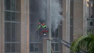 Firemen break the glass panels to allow the smoke to escape from the Resorts World Manila complex Friday, June 2, 2017 in suburban Pasay city, southeast of Manila, Philippines.(AP Photo) Firemen break the glass panels to allow the smoke to escape from the Resorts World Manila complex Friday, June 2, 2017 in suburban Pasay city, southeast of Manila, Philippines.(AP Photo)