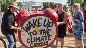 Protesters hold up signs during a demonstration in front of the White House in Washington, DC, objecting to US President Donald Trump's decision to withdraw from the Paris Climate accord.(AFP Photo) Protesters hold up signs during a demonstration in front of the White House in Washington, DC, objecting to US President Donald Trump's decision to withdraw from the Paris Climate accord.(AFP Photo)