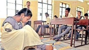 Laxmi Sanjay Shinde wrote her exams with her feet after she refused a writer provided by the state board.(HT PHOTO) Laxmi Sanjay Shinde wrote her exams with her feet after she refused a writer provided by the state board.(HT PHOTO)