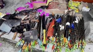 A compound crossbow and two longbows figured among the ’weapons’ seized during a televised raid conducted on the GJM office in Darjeeling.(PTI photo) A compound crossbow and two longbows figured among the ’weapons’ seized during a televised raid conducted on the GJM office in Darjeeling.(PTI photo)